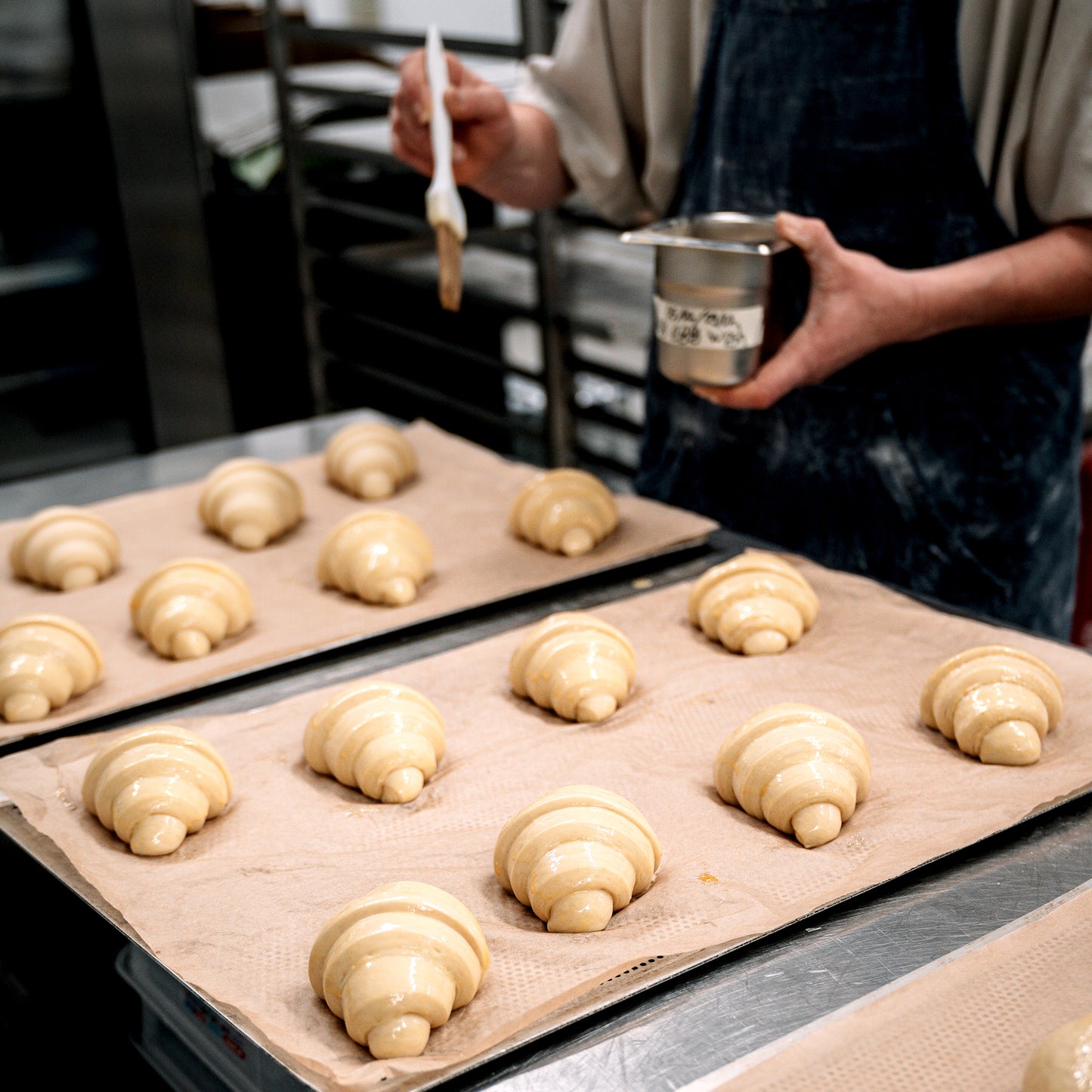 many croissants on a tray before they are baked.
